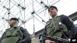 Armed police officers wearing bulletproof vests stand guard at the main train station in Berlin, 17 Nov 2010