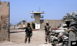 FILE - Iraqi army soldiers stand guard at the Abu Ghraib prison on the outskirts of Baghdad, Iraq, Sept. 2, 2006.