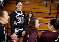 Marlene Kramer, center, attends a wrestling meet to watch her stepdaughter Sierra, 16, center left, cheerlead at a high school wrestling meet in Prairie du Chien, Wis., Jan. 19, 2017.