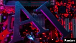 FILE - The letters AI (for Artificial Intelligence) and a robot's hand are seen against the backdrop of an illuminated computer motherboard in this illustration photo taken June 23, 2023.