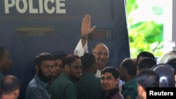 FILE - Salahuddin Quader Chowdhury, a senior opposition leader, waves to the media after he arrives at the war crime tribunal, in Dhaka, Bangladesh, Oct. 1, 2013.