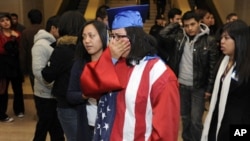 Students, some wearing graduation caps and gowns, cry after watching from the senate gallery as opponents block passage of the "Dream Act" at the U.S. Capitol in Washington, D.C., 18 Dec 2010