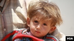 FILE - At the Za'atari camp in Jordan in June 2015, Morhaf's mother, Aziza Ghazawi, says all six of her children are in poor health since the war began.