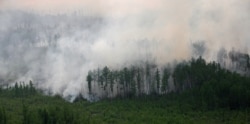 FILE - An aerial view shows the Taiga wood burning near the village of Boguchany, about 560 km (348 miles) northeast of Russia's Siberian city of Krasnoyarsk, June 2, 2011.
