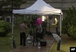 This image made from video shows foreign media activity outside Kalma Hotel in Wonsan, North Korea, May 22, 2018.