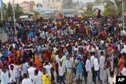 Protesters march near the scene of Saturday's massive truck bomb attack in Mogadishu, Somalia, Oct. 18, 2017.