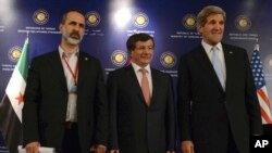 U.S. Secretary of State John Kerry, right, Turkish Foreign Minister Ahmet Davutoglu, center, and Syrian opposition leader Moaz al-Khatib pose for photos after a "Friends of Syria" group meeting at the Adile Sultan Palace, April 21, 2013, in Istanbul, Turk