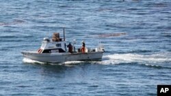 FILE - A small fishing boat is seen off California's coast, Oct. 9, 2011.