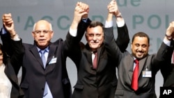 Libyan representatives from rival factions, left to right, Mohammed Chouaib, Fayez Sarraj, and Dr. Saleh Almkhozom react after signing a U.N.-sponsored deal aiming to end Libya's conflict, Dec.17, 2015 in Sikhrat, Morocco.