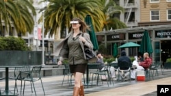 Yvonne Felix, of Canada, wears eSight electronic glasses and walks through Union Square during a visit to San Francisco, Feb. 2, 2017. The glasses enable the legally blind to see.