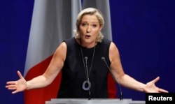 FILE - French far-right National Rally (Rassemblement National) party leader Marine Le Pen delivers her comeback speech in Frejus, France, Sept. 16, 2018.