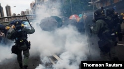 Demonstrators are caught in tear gas during a protest against the Yuen Long attacks in Yuen Long, New Territories, Hong Kong, July 27, 2019.