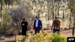 Australian Prime Minister Anthony Albanese, center, walks to a meeting with Indigenous leaders from central Australia in the Uluru Kata Tjuta National Park in central Australia on Oct. 10, 2023.