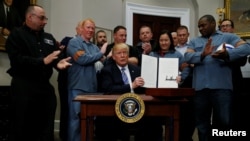 U.S. President Donald Trump, applauded by U.S. metal workers, is seen after signing a proclamation to introduce tariffs on imports of steel and aluminum, at the White House in Washington, March 8, 2018.
