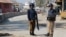 FILE - Policemen guard near the central prison where a court convicted 31 people over the campus lynching of a university student last year who was falsely accused of blasphemy, in Haripur, Pakistan, Feb. 7, 2018.