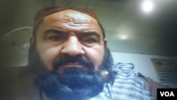 Handout photo showing Mullah Mansur at Pakistan's Federal Investigation Agency (FIA) immigration office on the Pakistan-Iran-Afghan border. He passed through the usual entry/exit booth in front of a computer, five hours before his killing.