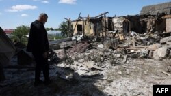 A local resident examines a private house destroyed by a missile attack in the village of Krasylivka, Kyiv region, on May 8, 2024, amid the Russia invasion in Ukraine.