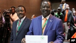 Orange Democratic Party presidential candidate, Raila Odinga (R), displays his registration certificate, with running mate Vice President Kalonzo Musyoka (L), in Nairobi, Kenya, January 30, 2013.