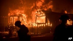 Flames from a wildfire consume a residence near Oroville, California, July 9, 2017. 