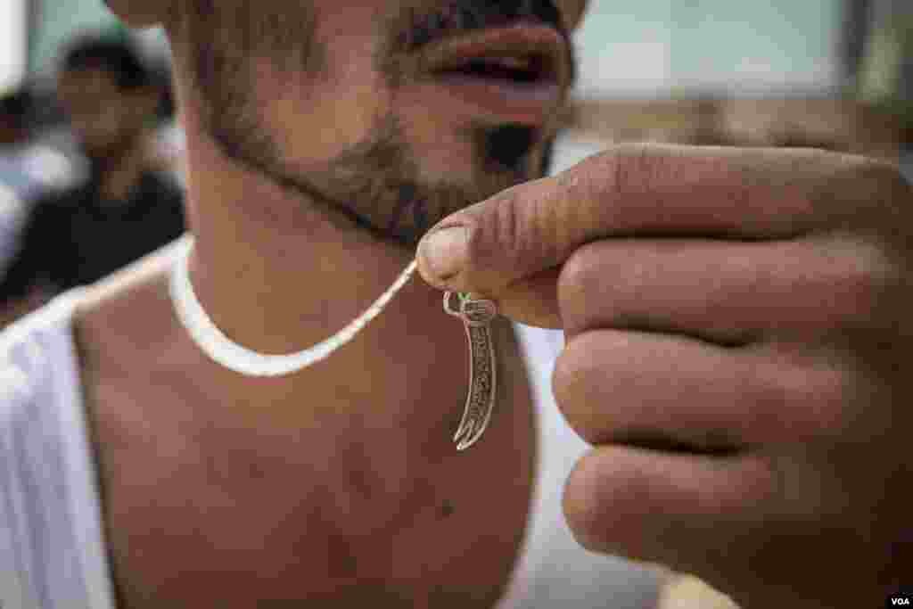 Ali Saeed, from Nabatieh, wears a pendent of the sword of Ali, father of Hussein. Named Zulfiqar, it was said to have been given to him by the Prophet Muhammad. (J. Owens/VOA)