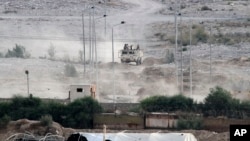 Egyptian soldiers sit atop a military personnel carrier securing the Egyptian side of the border between Egypt and Rafah in the southern Gaza Strip, July 1, 2015. 