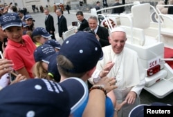 Pope Francis waves as he leaves at the end of his Wednesday general audience in Saint Peter's square at the Vatican, May 24, 2017.
