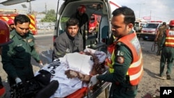 FILE - Pakistani rescue workers remove a body from the site of a deadly bombing in the eastern city of Lahore, Pakistan, July 24, 2017. 