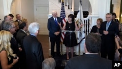 Vice President Mike Pence listens as his wife, Karen Pence, welcomes governors to the Naval Observatory Washington, Feb. 24, 2017.