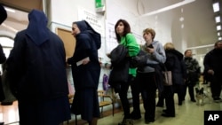 People line up at a polling station near the Vatican, in Rome, March 4, 2018.