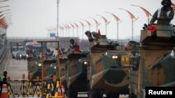 FILE - Amphibious assault vehicles of the South Korean Marine Corps travel during a military exercise as a part of the annual joint military training called Foal Eagle between South Korea and the U.S. in Pohang, South Korea, April 5, 2018.