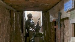 FILE - A Ukrainian soldier is seen at fighting positions on the line of separation from pro-Russian rebels near Donetsk, Ukraine, April 19, 2021.