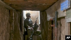 A Ukrainian soldier is seen at fighting positions on the line of separation from pro-Russian rebels near Donetsk, Ukraine, April 19, 2021.