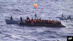 Migrants receive help from the Italian Navy off the Sicilian island of Lampedusa Oct.12, 2013.