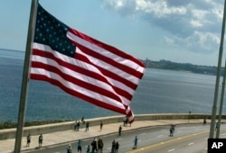 The U.S. flag waves outside the newly opened U.S. Embassy, overlooking Havana's seaside boulevard, the Malecon in Cuba, Aug. 14, 2015.