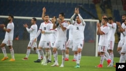 Iran's players acknowledge their supporters following a friendly soccer match between Turkey and Iran, in Istanbul, May 28, 2018. The world's largest footwear maker, Nike, says it cannot provide shoes for the Iranian team because of the Trump administration's plan to re-impose U.S. sanctions on Iran.