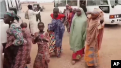 Screen shot of the bus provided by state government carrying freed hostages, who were held by bandits, driving through transit site after being brought from where they were freed in Gusau, Zamfara state on Jan. 04, 2022.