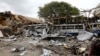 A view shows the damaged structures and school buses at the scene after a car exploded in a suicide attack near Mucassar primary and secondary school in Hodan district of Mogadishu, Somalia, Nov. 25, 2021.