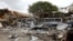 A view shows the damaged structures and school buses at the scene after a car exploded in a suicide attack near Mucassar primary and secondary school in Hodan district of Mogadishu, Somalia, Nov. 25, 2021.