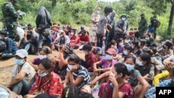 In this handout photo from the Royal Thai Army taken and released on Nov. 1, 2021, Myanmar migrants are pictured after being apprehended by Thai military personnel in Kanchanaburi province, bordering Myanmar. 