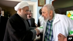 Cuba's former leader Fidel Castro, right, shakes hands with Iranian President Hassan Rouhani in Havana, Cuba, Monday, Sept 19, 2016.