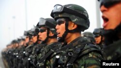 Paramilitary policemen stand in formation as they take part in an anti-terrorism oath-taking rally, in Kashgar, Xinjiang Uighur Autonomous Region, China, February 27, 2017.