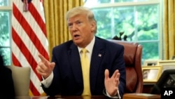FILE - President Donald Trump speaks in the Oval Office of the White House in Washington, Oct. 11, 2019. 
