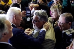 Democratic presidential candidate Joe Biden, at left, talks with supporters during a primary election night rally in Los Angeles, California, March 3, 2020.