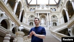 FILE - Austrian data activist Max Schrems stands in the courthouse after his trial against Facebook in Vienna, April 9, 2015.