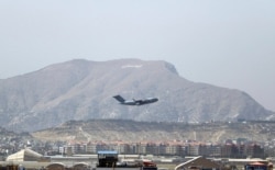 FILE - A US military aircraft takes off at Hamid Karzai International Airport in Kabul, Aug. 28, 2021.