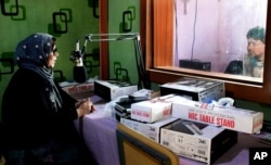 Zarghona Hassan, an activist and the founder of Radio Shaesta station prepares to go on-air, in Kunduz, Afghanistan, March 4, 2016.