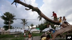 Children play in the tent city for typhoon survivors in the Philippines city of Tacloban, Leyte province, Nov. 7, 2014.