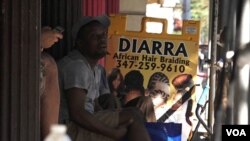 A group of African men chat on a stoop in Little Senegal, Harlem. (R. Taylor/VOA)