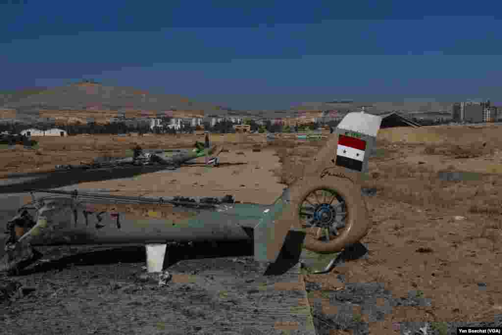 Several military helicopters used by the Syrian forces during the civil war were destroyed by Israeli air strikes in the Mazzeh Air Base last week, in Damascus, on Dec. 19, 2024. (Yan Boechat/VOA)