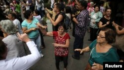 FILE - Elderly people dance on a street during the International Day of Older Persons in Sao Paulo's Avenida Paulista, Brazil, October 2013.